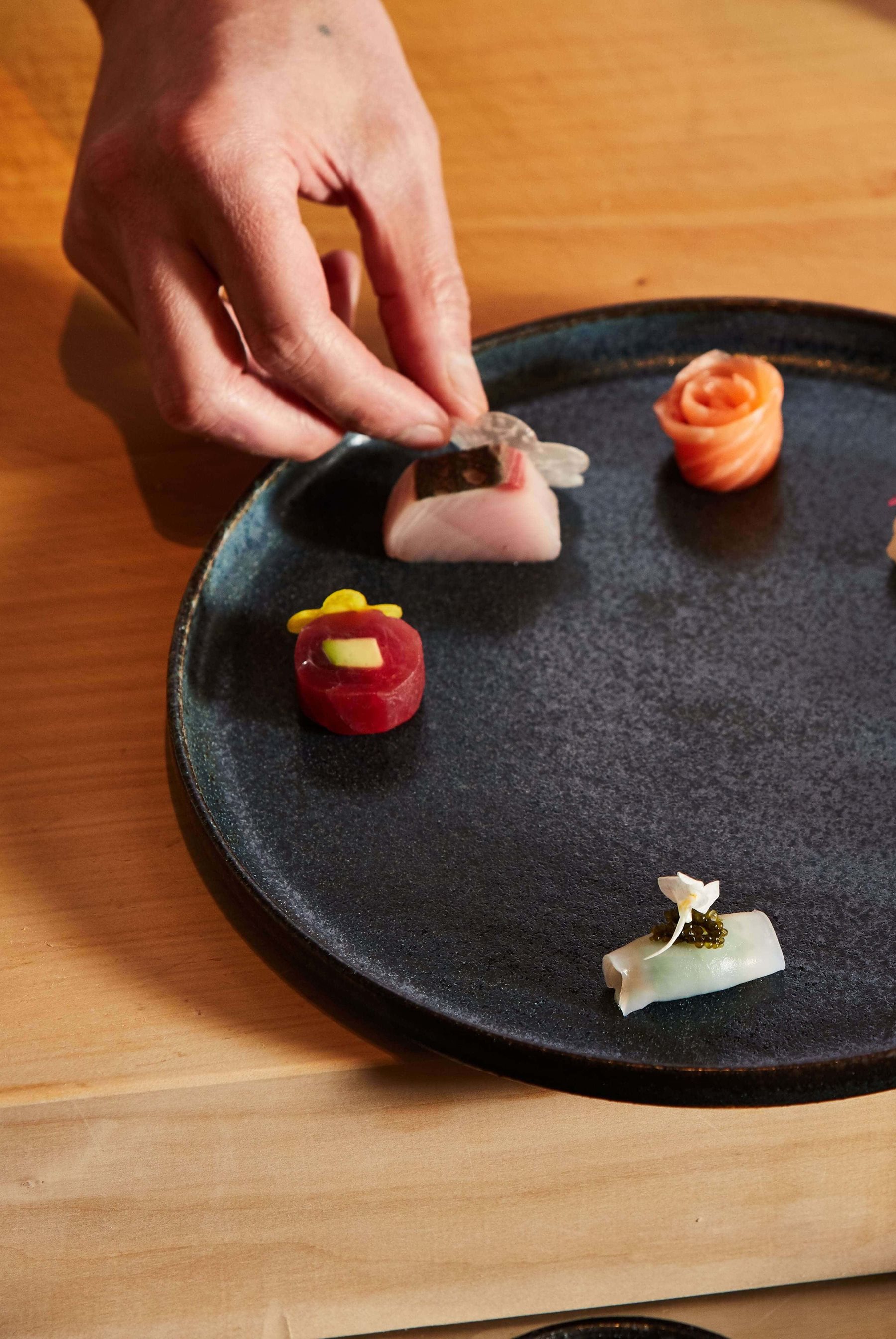 Crown chef preparing sashimi dish
