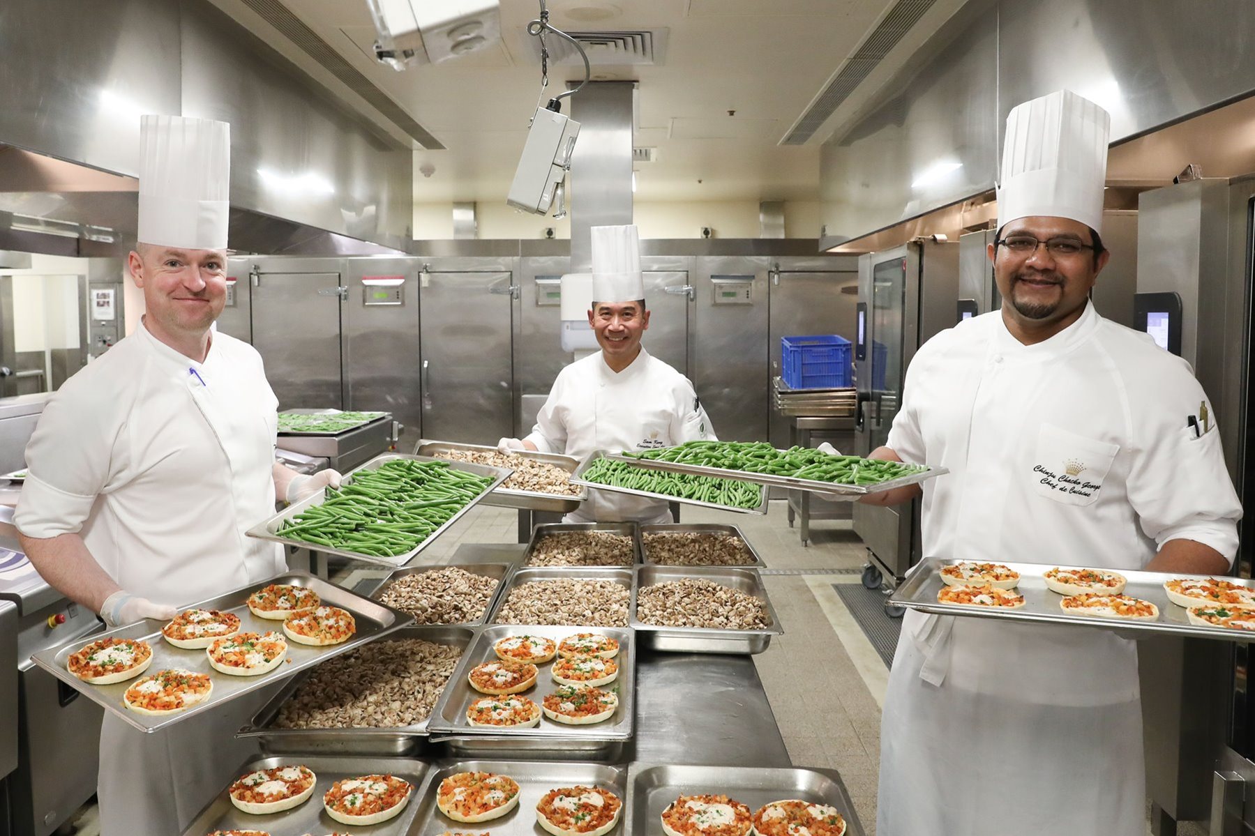 Crown Resort chefs holding food trays
