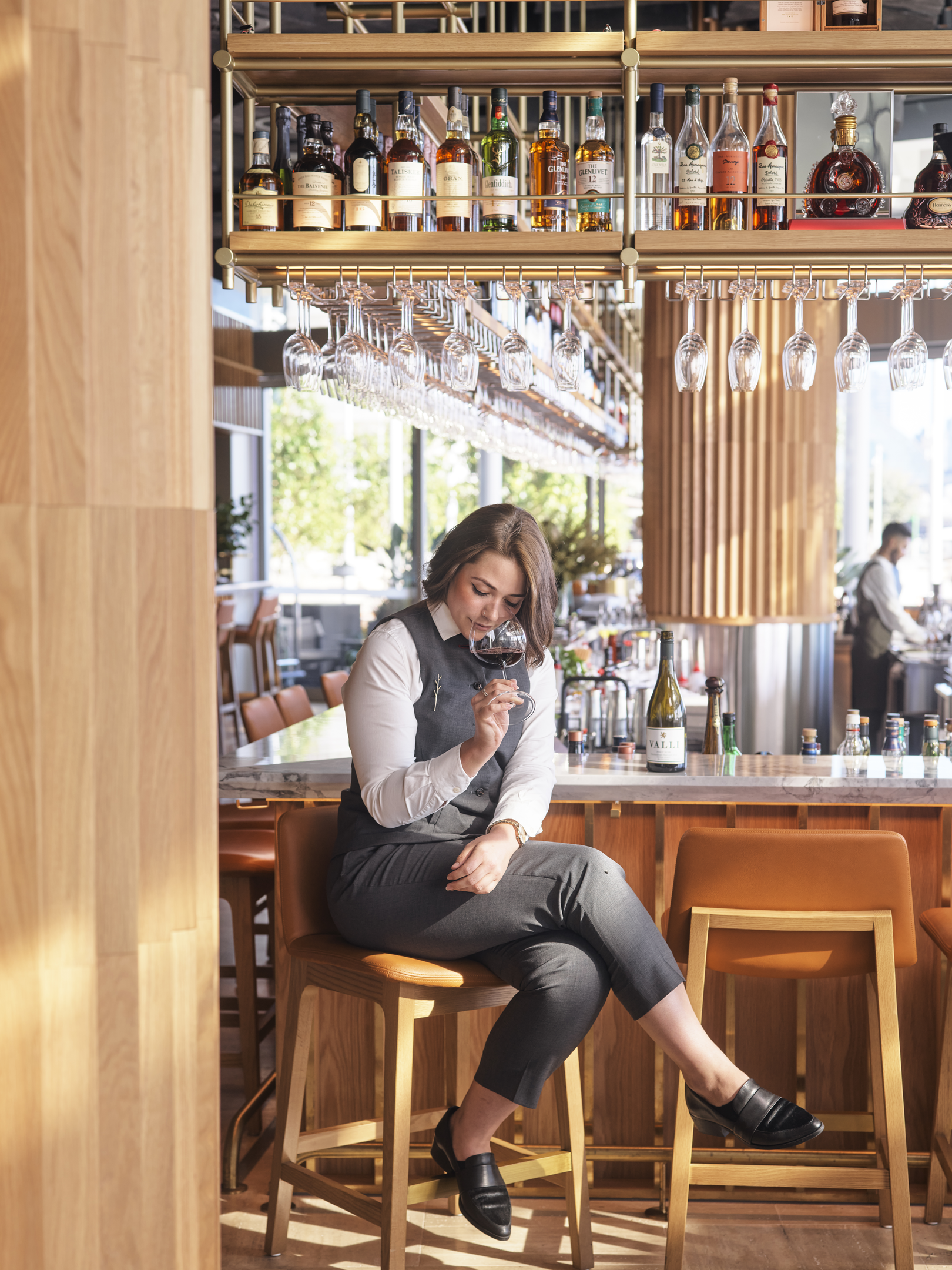 waitress with wine at woodcut bar