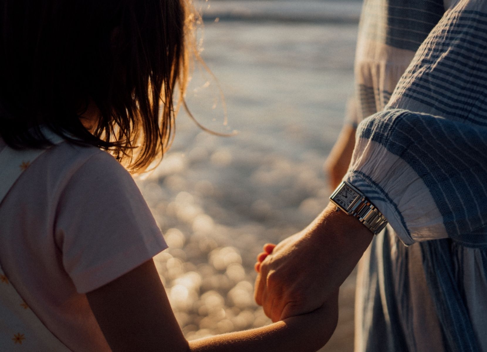 a parent wearing a timepiece from Watches of Switzerland
